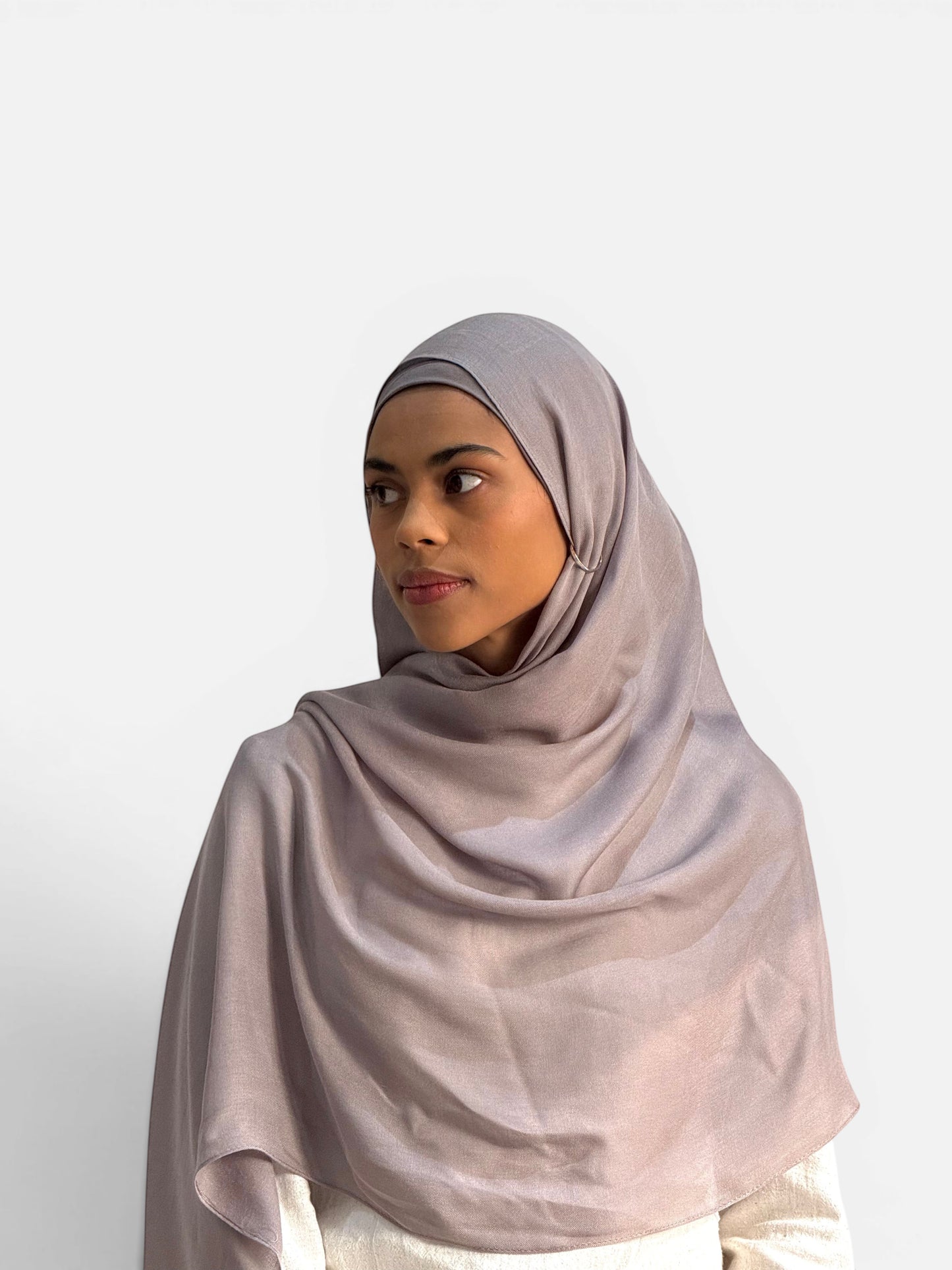 SAHR STUDIOS pebble grey modal hijab scarf with matching undercap worn by a model against a white background