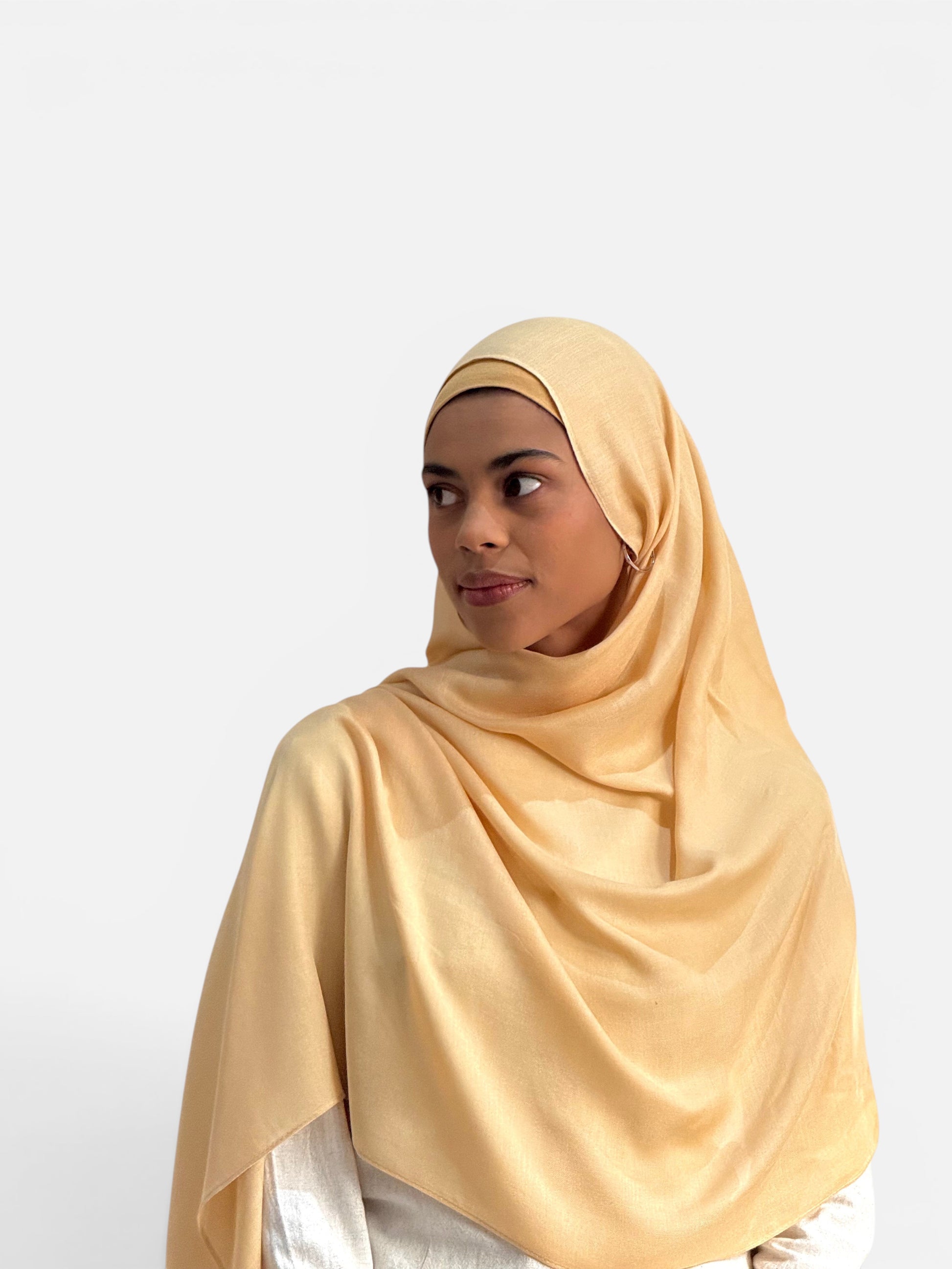 SAHR STUDIOS Sunbeam yellow modal hijab scarf and matching undercap worn by a model with a soft, breathable drape.